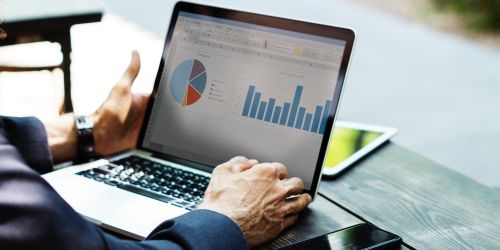 man using laptop to monitor work