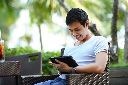 Man sitting outside on an Ipad