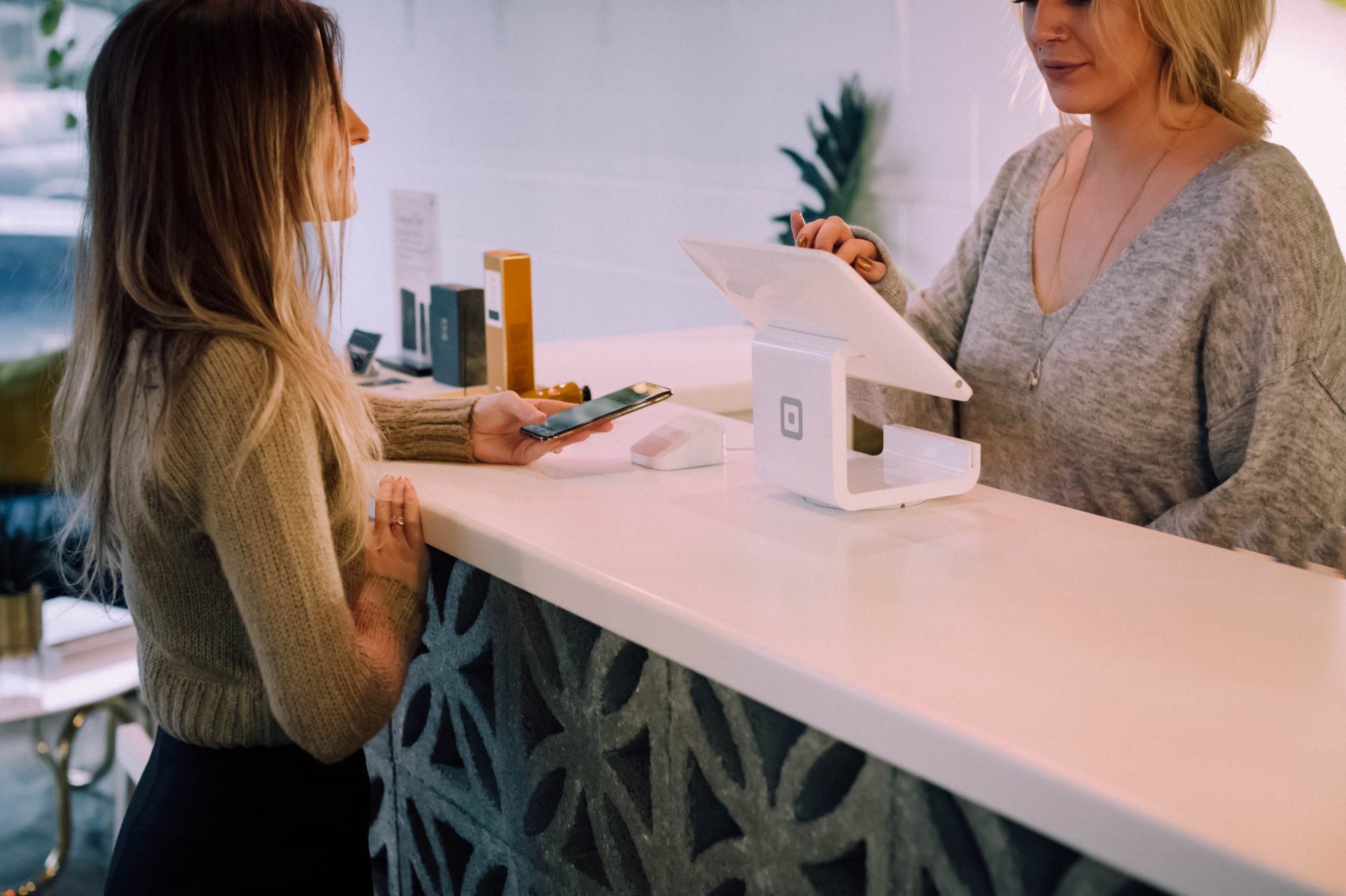 A customer making a purchase at a register 