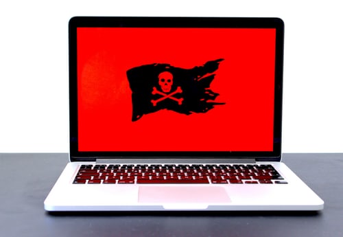 A red laptop screen with a pirate logo 