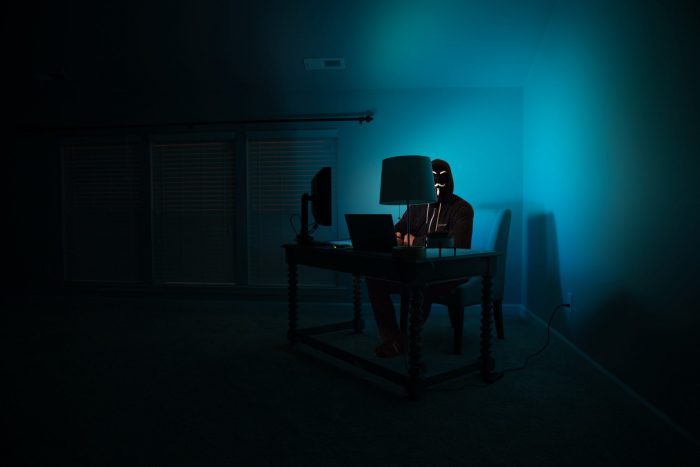 Man in dark room on computer 