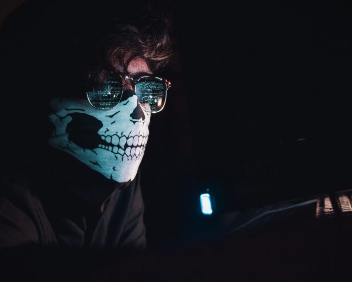 Man wearing a mask at computer