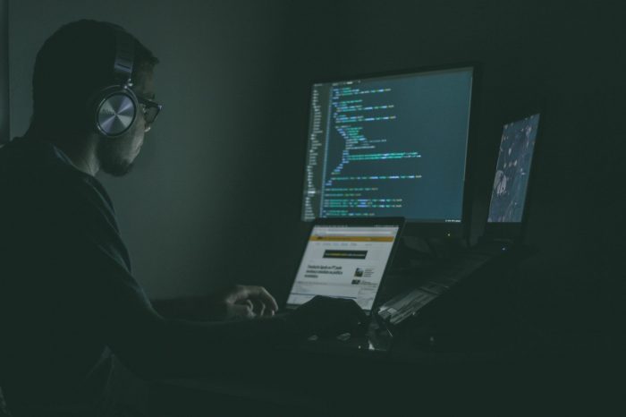 A man staring at two screens