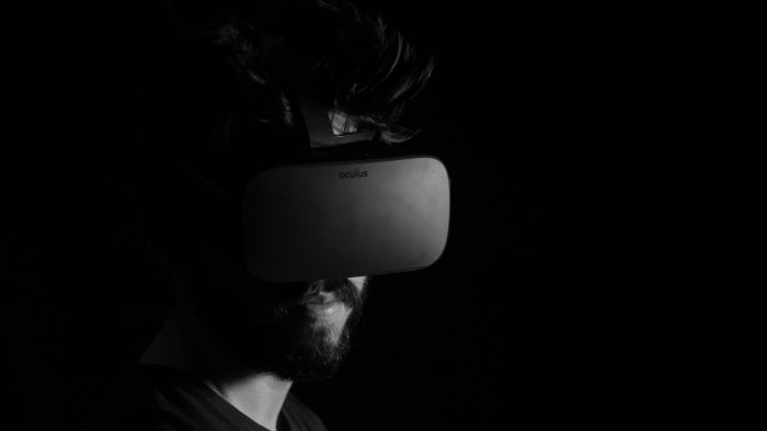 Man in a VR headset with a black background