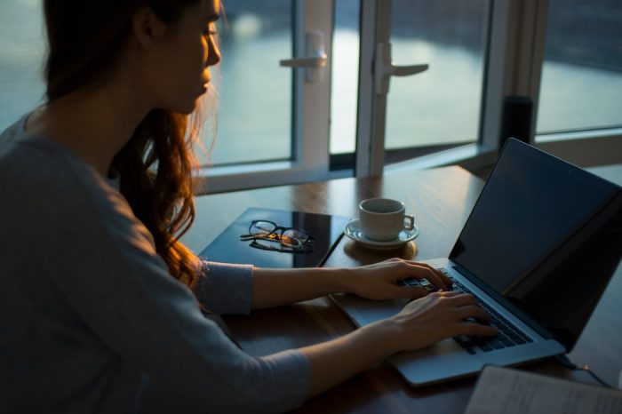 A woman working on a laptop in her home 