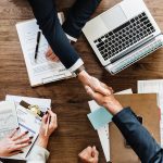 men handshaking during a meeting