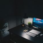 computer on a desk in a dark room