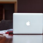 Apple Laptop on Desk with Notebooks