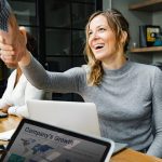 Business Interactions around laptop- shaking hands