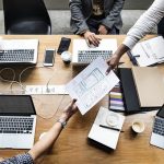 people sitting at a table in a meeting