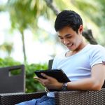 Man sitting outside on an Ipad