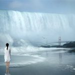 woman looking at waterfall