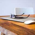 glasses sitting on top of a laptop