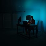 Man in dark room on computer