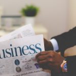 A Man reading the business section of a newspaper