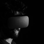 Man in a VR headset with a black background