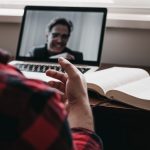 A man video chatting on a laptop